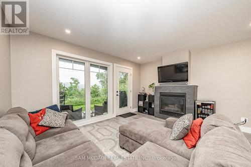 102 - 4 Tree Tops Lane, Huntsville, ON - Indoor Photo Showing Living Room With Fireplace