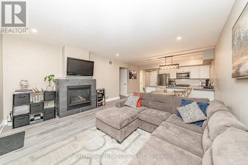 102 - 4 Tree Tops Lane, Huntsville, ON - Indoor Photo Showing Living Room With Fireplace