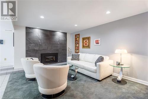 Tiled living room with a tiled fireplace - 103 Mcgregor Crescent, Ancaster, ON - Indoor Photo Showing Living Room With Fireplace