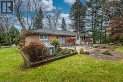 Back of house with a lawn and a patio area - 