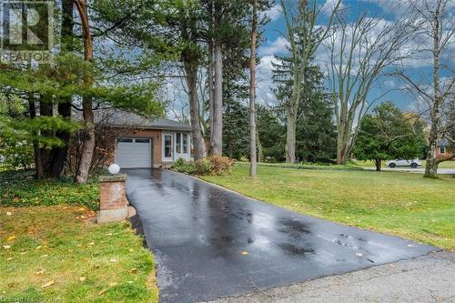 View of front of property featuring a garage and a front yard - 103 Mcgregor Crescent, Ancaster, ON - Outdoor