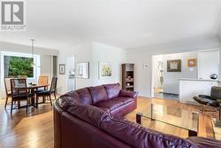 Living room featuring hardwood / wood-style flooring and crown molding - 