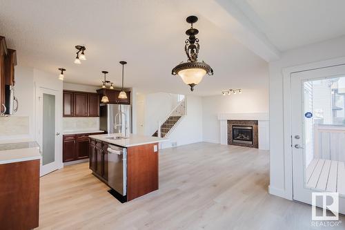 8017 Shaske Dr Nw, Edmonton, AB - Indoor Photo Showing Kitchen With Fireplace With Stainless Steel Kitchen