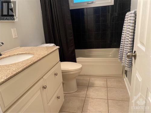 bathroom, soaker tub, vanity with granite counter & ceramic flooring - 210 Harcourt Avenue, Ottawa, ON - Indoor Photo Showing Bathroom