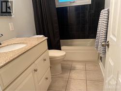 bathroom, soaker tub, vanity with granite counter & ceramic flooring - 