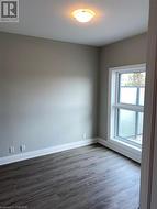 Spare room featuring dark wood-type flooring - 