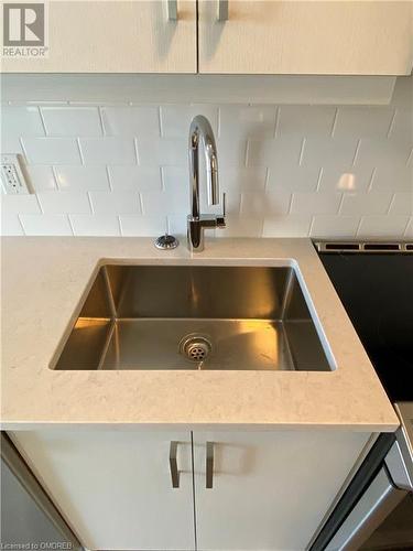 Interior details featuring sink - 128 Grovewood Common Unit# 117, Oakville, ON - Indoor Photo Showing Kitchen With Double Sink