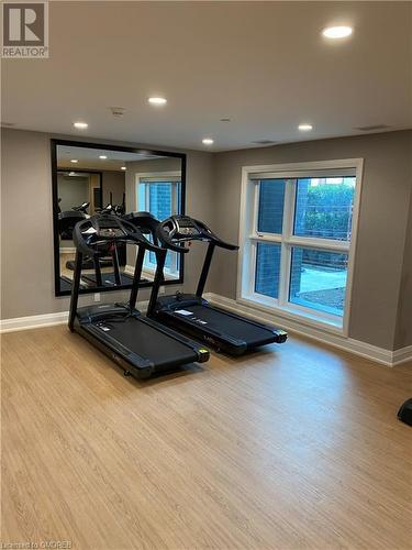 Exercise area featuring light hardwood / wood-style floors - 128 Grovewood Common Unit# 117, Oakville, ON - Indoor Photo Showing Gym Room