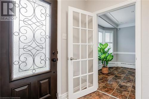 Foyer with a baseboard radiator - 15 Empress Avenue, Hamilton, ON 