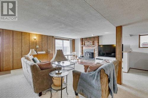 84 Range Way Nw, Calgary, AB - Indoor Photo Showing Living Room With Fireplace