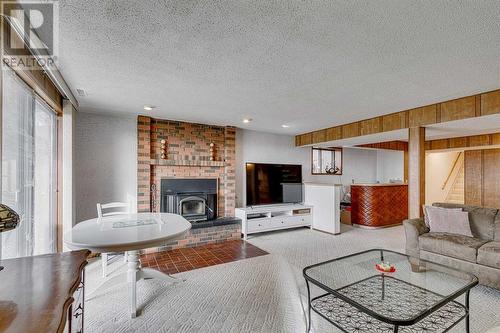 84 Range Way Nw, Calgary, AB - Indoor Photo Showing Living Room With Fireplace