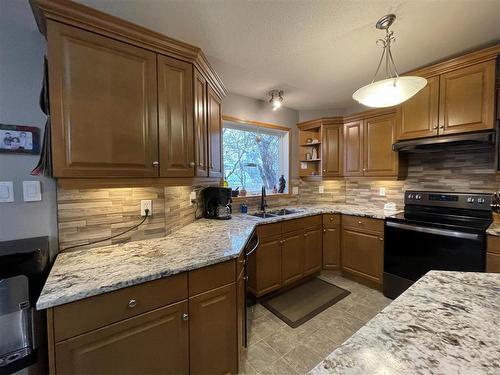 412 Centennial Drive S, Swan River, MB - Indoor Photo Showing Kitchen With Double Sink