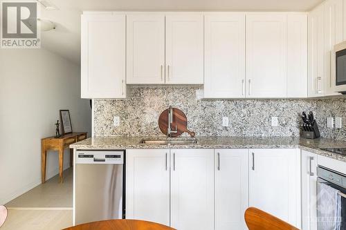 Quartz counters and backsplash. - 805 Carling Avenue Unit#708, Ottawa, ON - Indoor Photo Showing Kitchen With Upgraded Kitchen