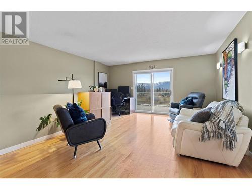 Sliding doors lead to 340 sqft sundeck/balcony with STUNNING views - 1631 60 Street Ne, Salmon Arm, BC - Indoor Photo Showing Living Room