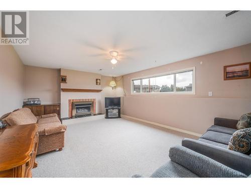 Family room downstairs w/ gas fireplace - 1251 Ortt Place, Kelowna, BC - Indoor Photo Showing Living Room With Fireplace