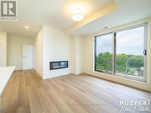 705 - 118 West Street, Port Colborne (Sugarloaf), ON - Indoor Photo Showing Living Room With Fireplace