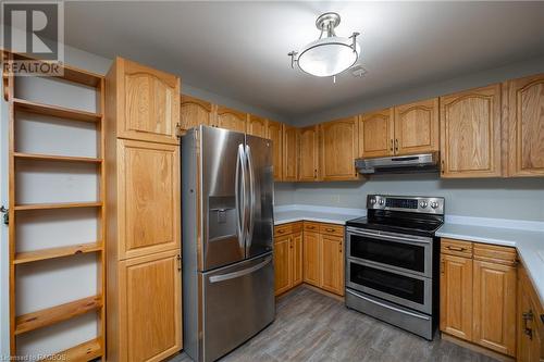 Kitchen featuring stainless steel appliances and wood-type flooring - 2555 3Rd 3Rd Avenue Avenue W Unit# 210, Owen Sound, ON - Indoor Photo Showing Kitchen