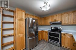 Kitchen featuring stainless steel appliances and wood-type flooring - 