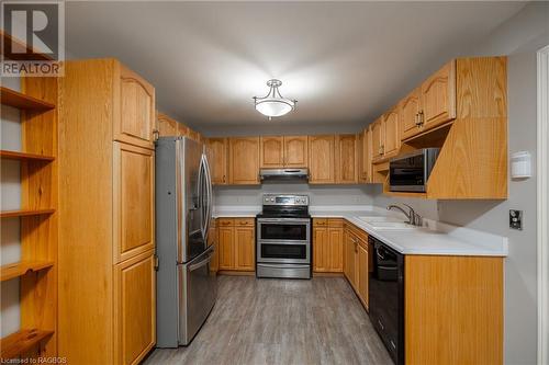 Kitchen with hardwood / wood-style floors, sink, stainless steel appliances, and extractor fan - 2555 3Rd 3Rd Avenue Avenue W Unit# 210, Owen Sound, ON - Indoor Photo Showing Kitchen