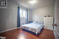 Bedroom featuring dark wood-type flooring - 