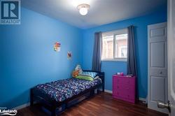 Bedroom featuring dark hardwood / wood-style flooring - 