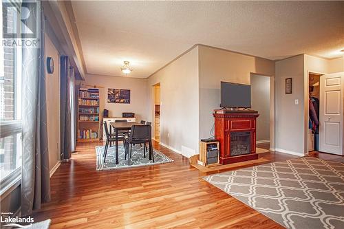 Dining room with hardwood / wood-style floors and a textured ceiling - 96 Sixth Street, Midland, ON - Indoor