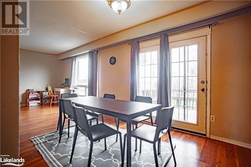 Dining area with hardwood / wood-style floors, a healthy amount of sunlight, and a textured ceiling - 96 Sixth Street, Midland, ON - Indoor Photo Showing Dining Room