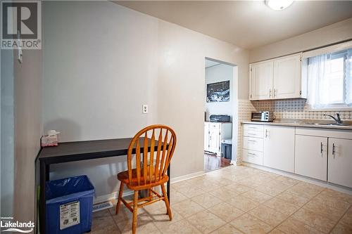 Kitchen with white cabinets, backsplash, built in desk, and sink - 96 Sixth Street, Midland, ON - Indoor Photo Showing Other Room