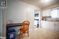 Kitchen with white cabinets, backsplash, built in desk, and sink - 