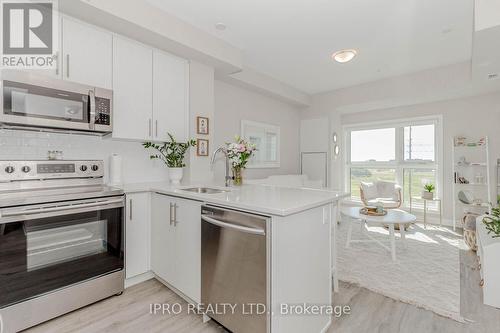 318 - 128 Grovewood Common, Oakville, ON - Indoor Photo Showing Kitchen With Upgraded Kitchen