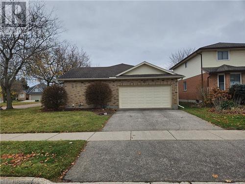 View of front of home with a front lawn and a garage - 551 Hallmark Drive, Waterloo, ON - Outdoor With Facade