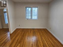 Unfurnished room featuring dark hardwood / wood-style floors - 