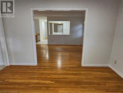 Empty room featuring dark hardwood / wood-style flooring - 