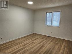 Spare room with dark wood-type flooring - 