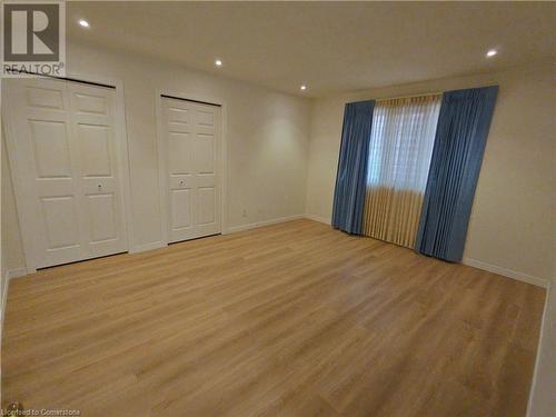 Unfurnished bedroom featuring light hardwood / wood-style floors and multiple closets - 551 Hallmark Drive, Waterloo, ON - Indoor Photo Showing Other Room