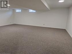 Basement featuring dark colored carpet - 