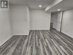 Spare room featuring a textured ceiling and dark hardwood / wood-style flooring - 