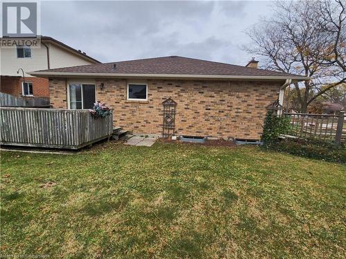 Rear view of house featuring a lawn and a deck - 551 Hallmark Drive, Waterloo, ON - Outdoor