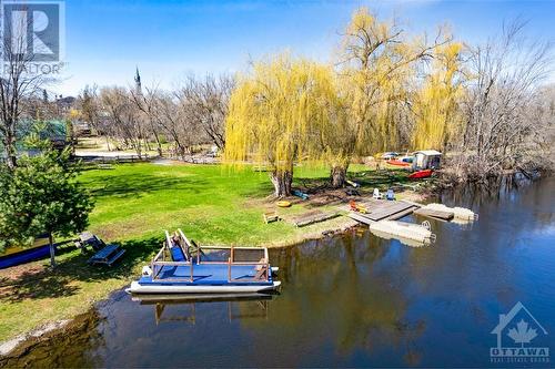 Clear waterfront with 3 docks for rental kayaks, canoes and Corcls - 21 Craig Street, Perth, ON - Outdoor With Body Of Water With View