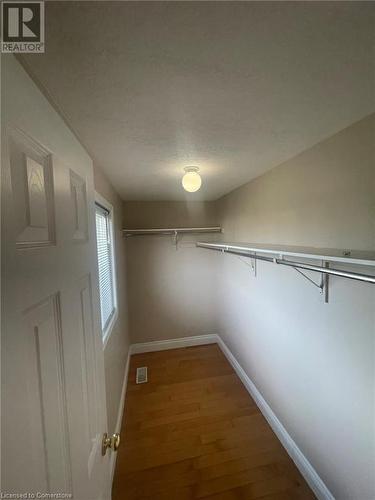 Walk in closet featuring hardwood / wood-style floors - 126 Peach Blossom Crescent, Kitchener, ON - Indoor With Storage