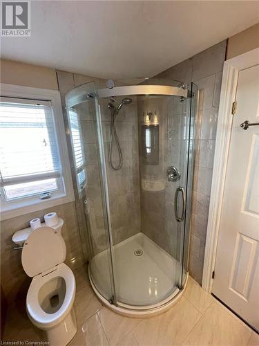 Bathroom featuring tile patterned floors, toilet, and a shower with shower door - 126 Peach Blossom Crescent, Kitchener, ON - Indoor Photo Showing Bathroom