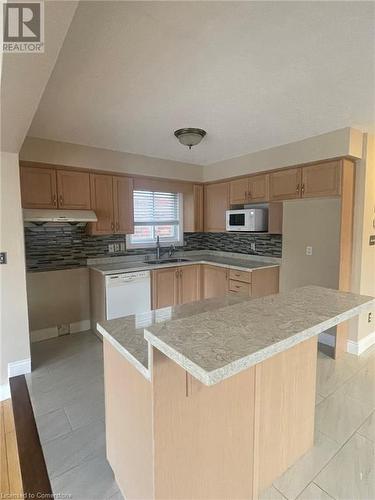 Kitchen with white appliances, sink, and tasteful backsplash - 126 Peach Blossom Crescent, Kitchener, ON - Indoor Photo Showing Kitchen