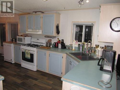 4776 Moneeyaw Road, 108 Mile Ranch, BC - Indoor Photo Showing Kitchen With Double Sink