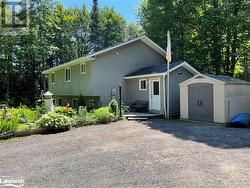 Back of property featuring a storage shed - 