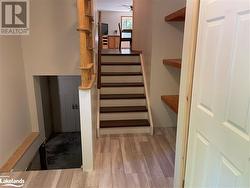 Staircase featuring wood-type flooring and ceiling fan - 