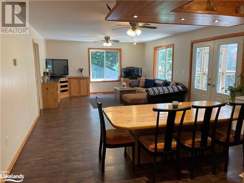 Dining space with french doors, dark hardwood / wood-style floors, a wealth of natural light, and ceiling fan - 1010 Fern Glen Road, Emsdale, ON - Indoor Photo Showing Dining Room