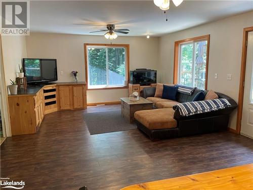 Living room featuring ceiling fan, dark hardwood / wood-style flooring, and a healthy amount of sunlight - 1010 Fern Glen Road, Emsdale, ON - Indoor Photo Showing Living Room