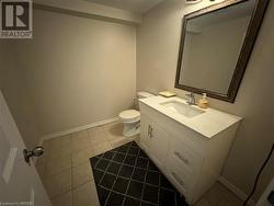 Bathroom featuring tile patterned floors, vanity, and toilet - 