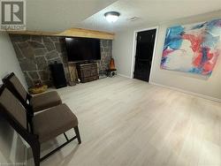 Living room featuring a textured ceiling and light wood-type flooring - 