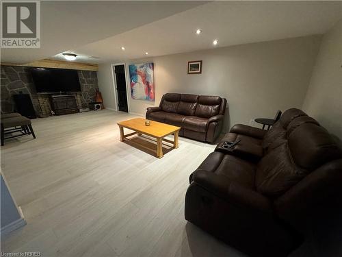 Living room featuring a stone fireplace and light hardwood / wood-style flooring - 3877 Hwy 17 E, Mattawa, ON - Indoor